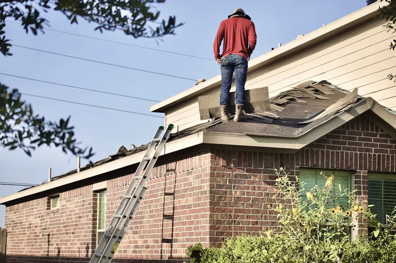 Professional roofer working on a residential roof in Weehawken